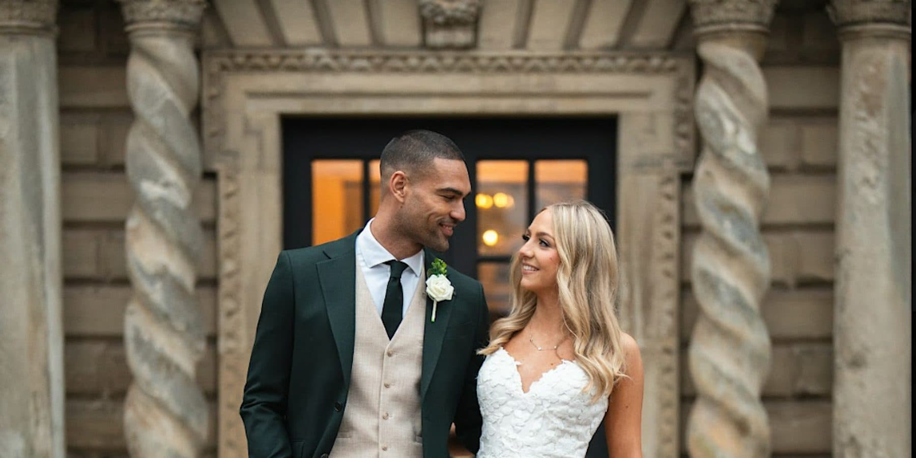 A newly married couple outside the entrance to Castle Bromwich Hall Hotel